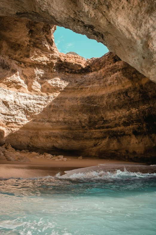 an ocean filled with water and a small cave