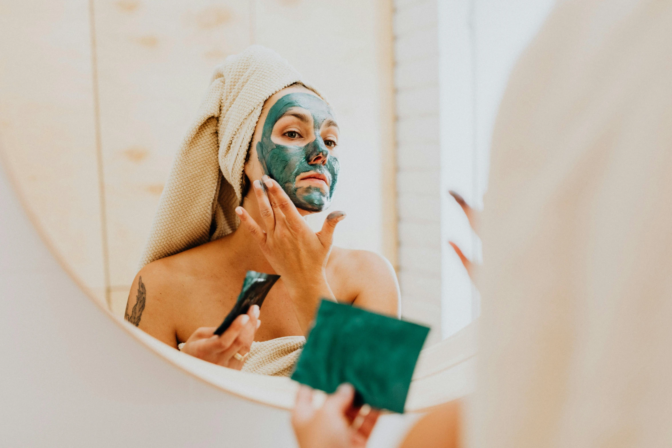 a woman using the shaving mask on her face