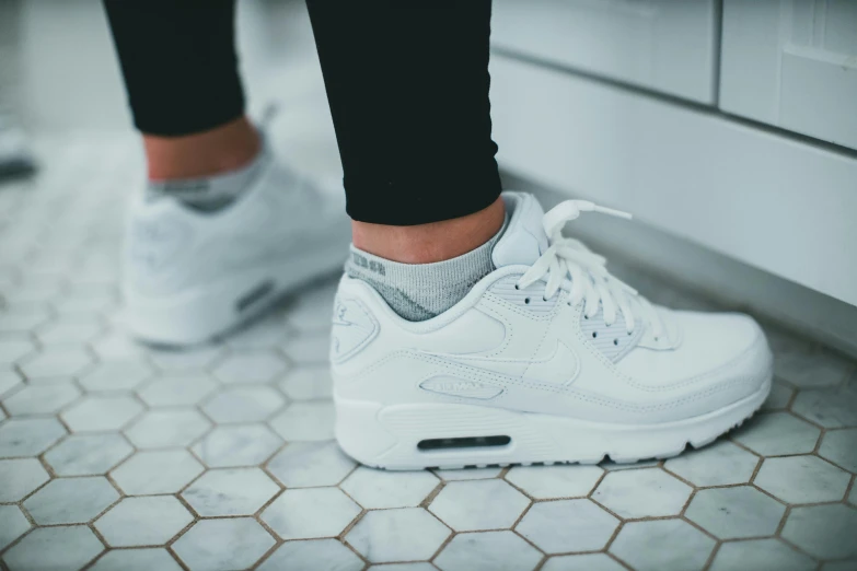 a woman's white nike air max shoes