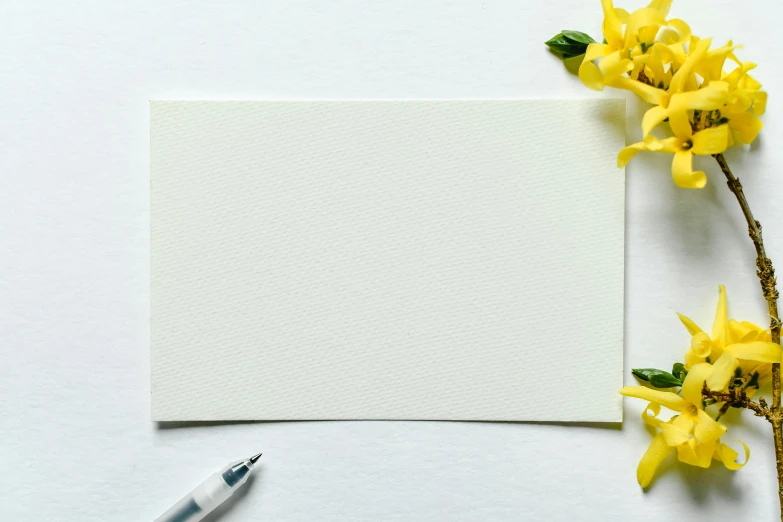 a card surrounded by some flowers on a table