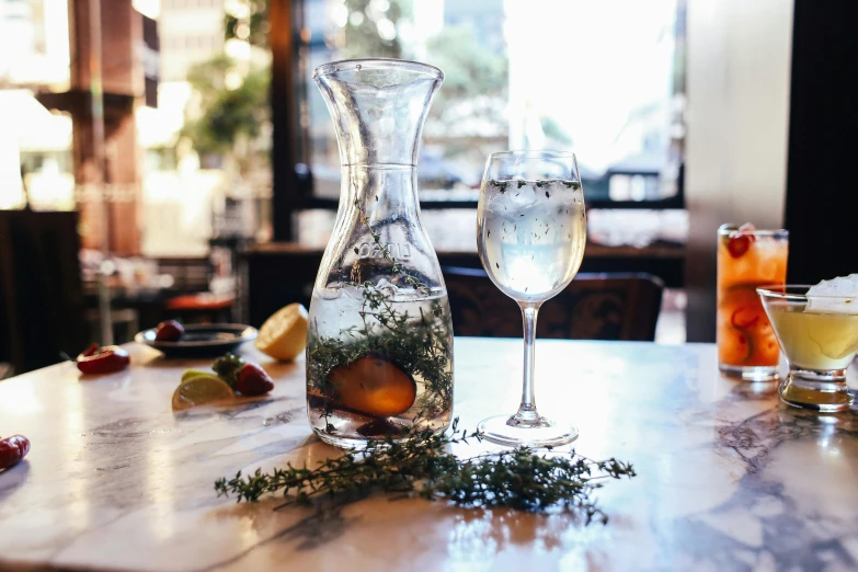 a table with two pitchers of wine and two flutes