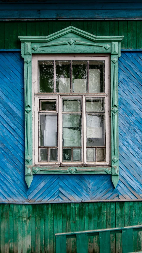 an old window is attached to a wooden building