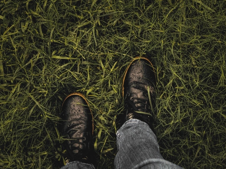 feet of a person standing in some grass
