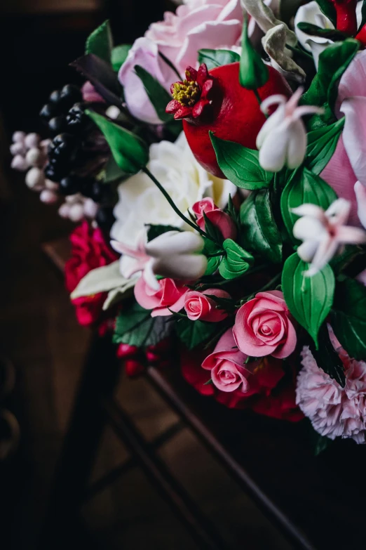 a bouquet of pink and white flowers is displayed