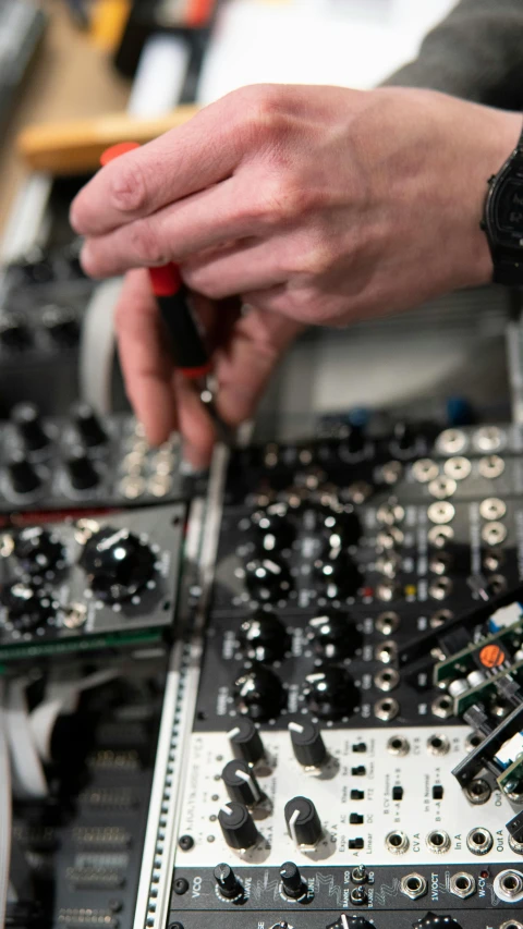 a dj using control equipment to record various tracks