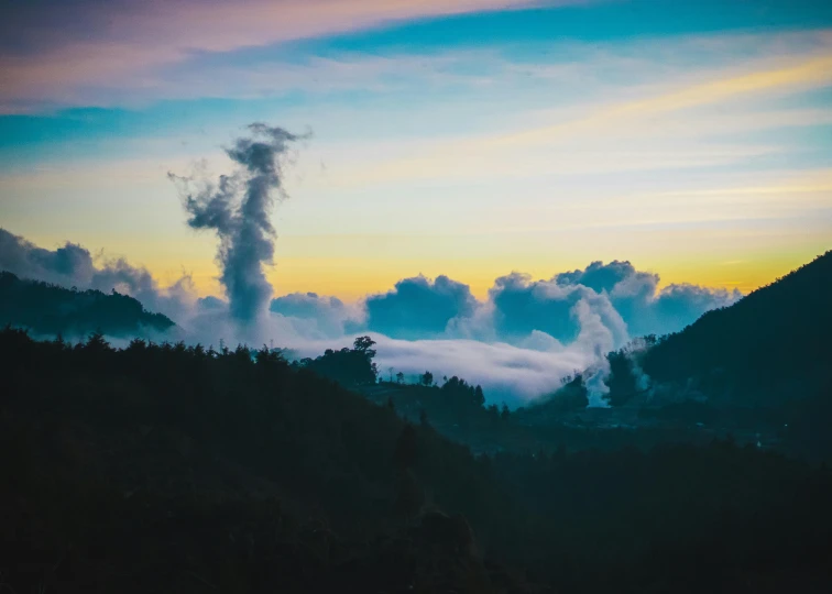 a plume of smoke rising out of the mountain