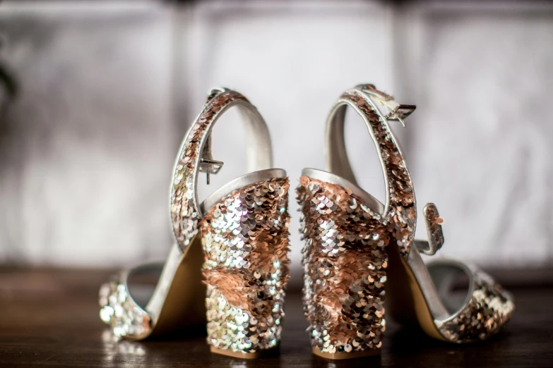 two pairs of brides shoes with a shoe heel decorated with shiny sequins