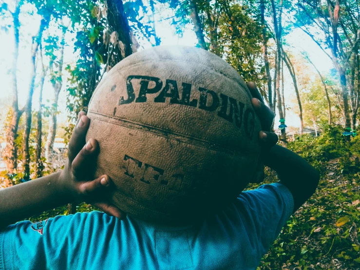 a man holding a large ball in the air