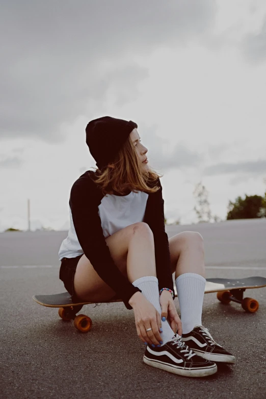 a man that is sitting on top of a skateboard