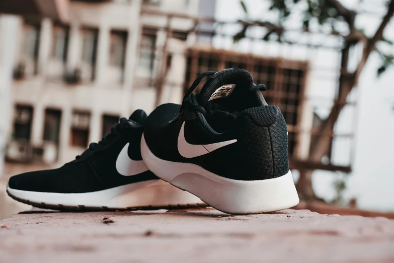 a black and white nike sneakers with a tan top