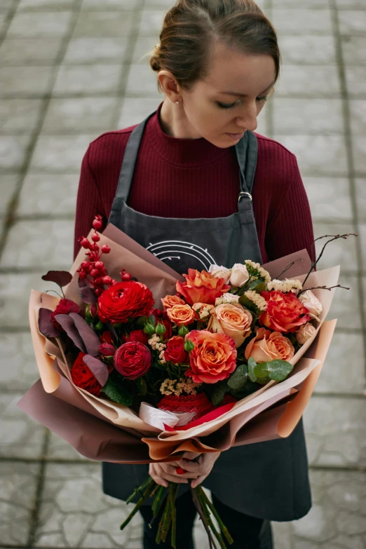 a woman with long hair holding a bouquet of flowers