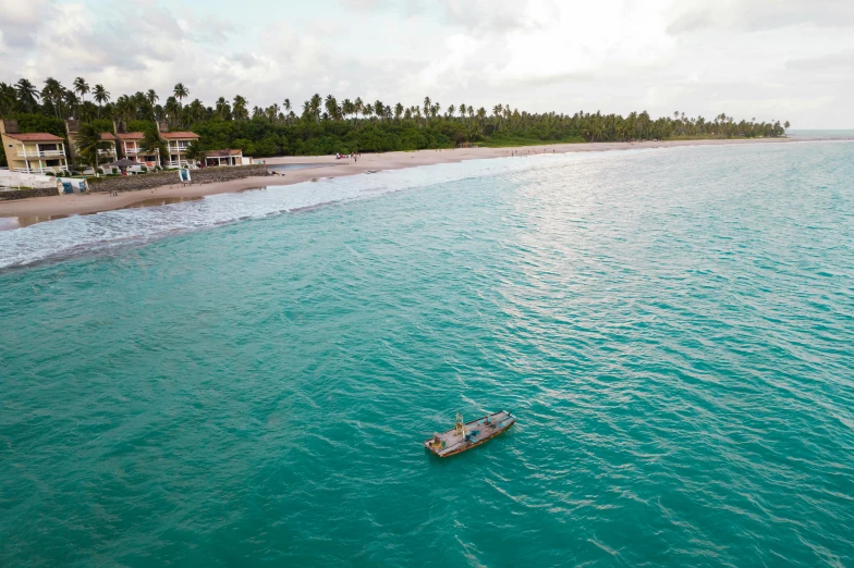 a view of a beach with several boats out on the water