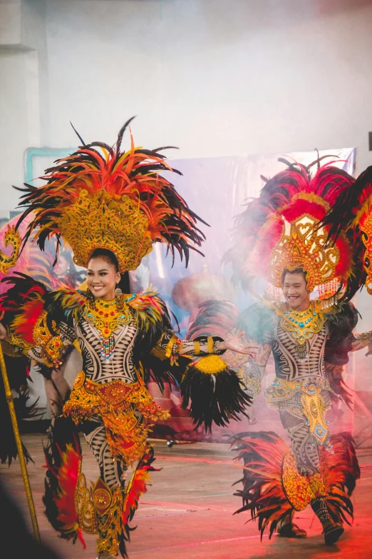 two performers in elaborately dressed costumes at an event