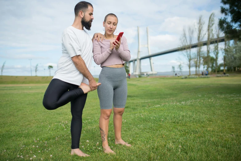 a man and a woman taking pictures on their cell phones