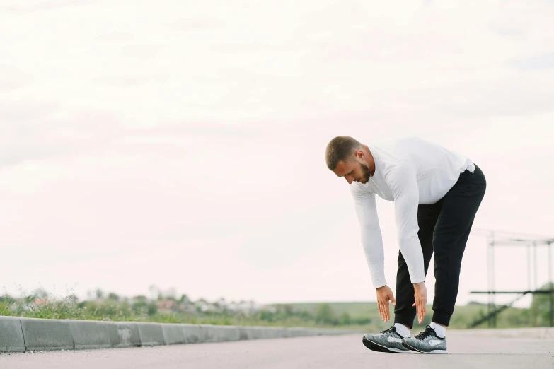 a man is doing soing outdoors on a skate board