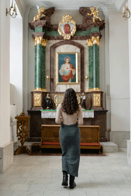 a lady that is standing in front of some pictures