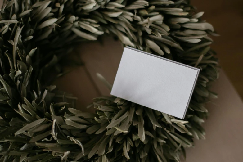 a close up of a wreath with a white square on it