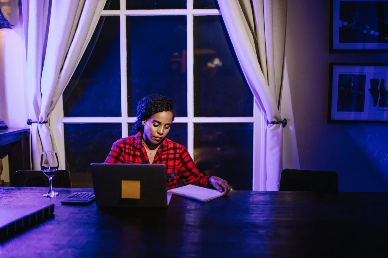 a woman sitting at her laptop with the screen up