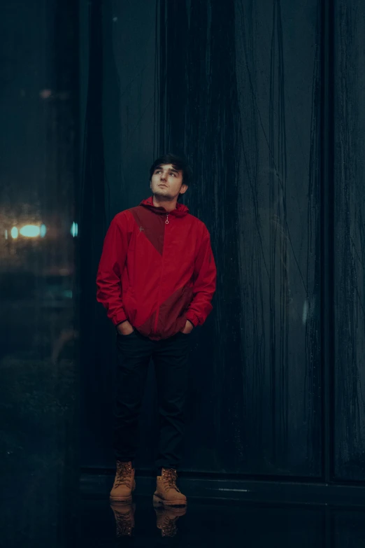 a person wearing a red sweater and black pants stands near a doorway