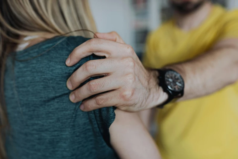 a man holding the hands of a woman