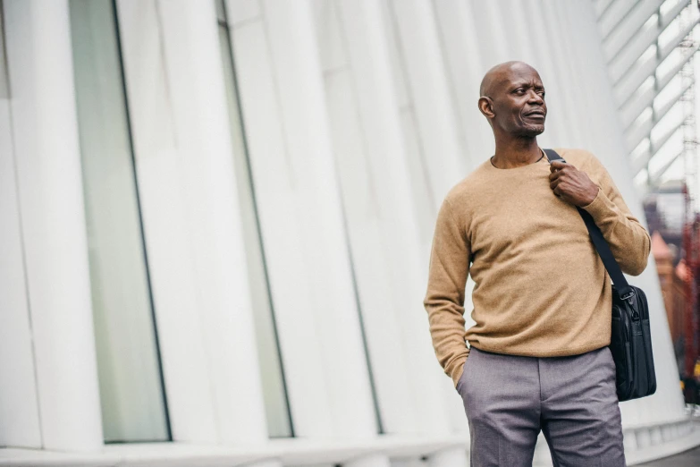 a man standing outside a building while smoking a cigarette