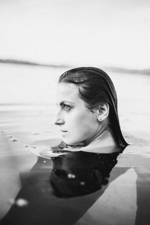 a black and white po of a woman in the water