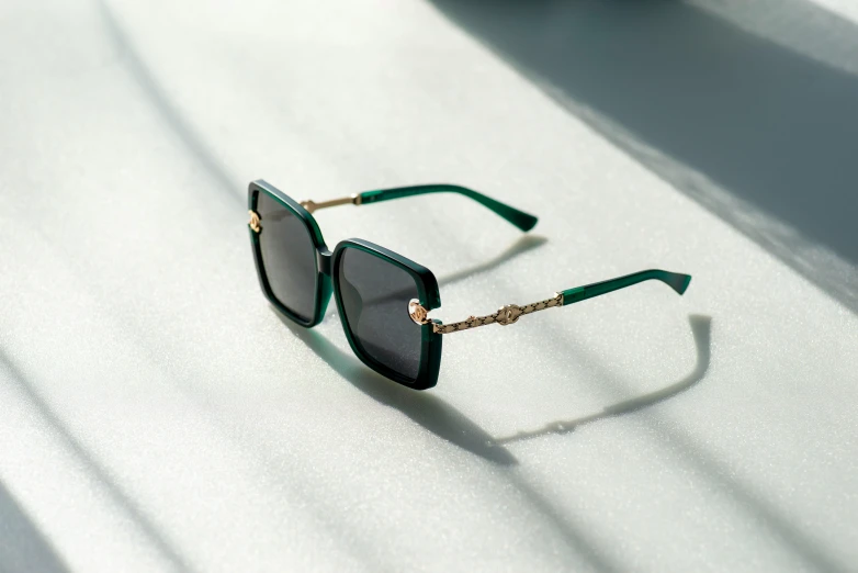 a pair of green glasses with matching chains