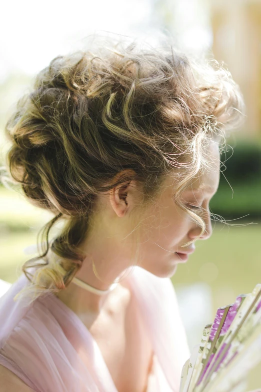 the woman is wearing a pink dress and holding a white parasol