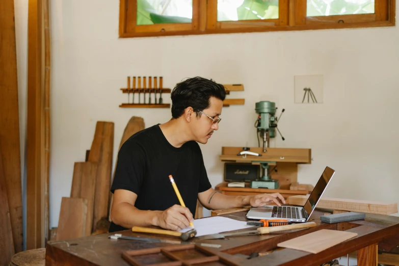 a man sitting at a desk with a notebook and pen