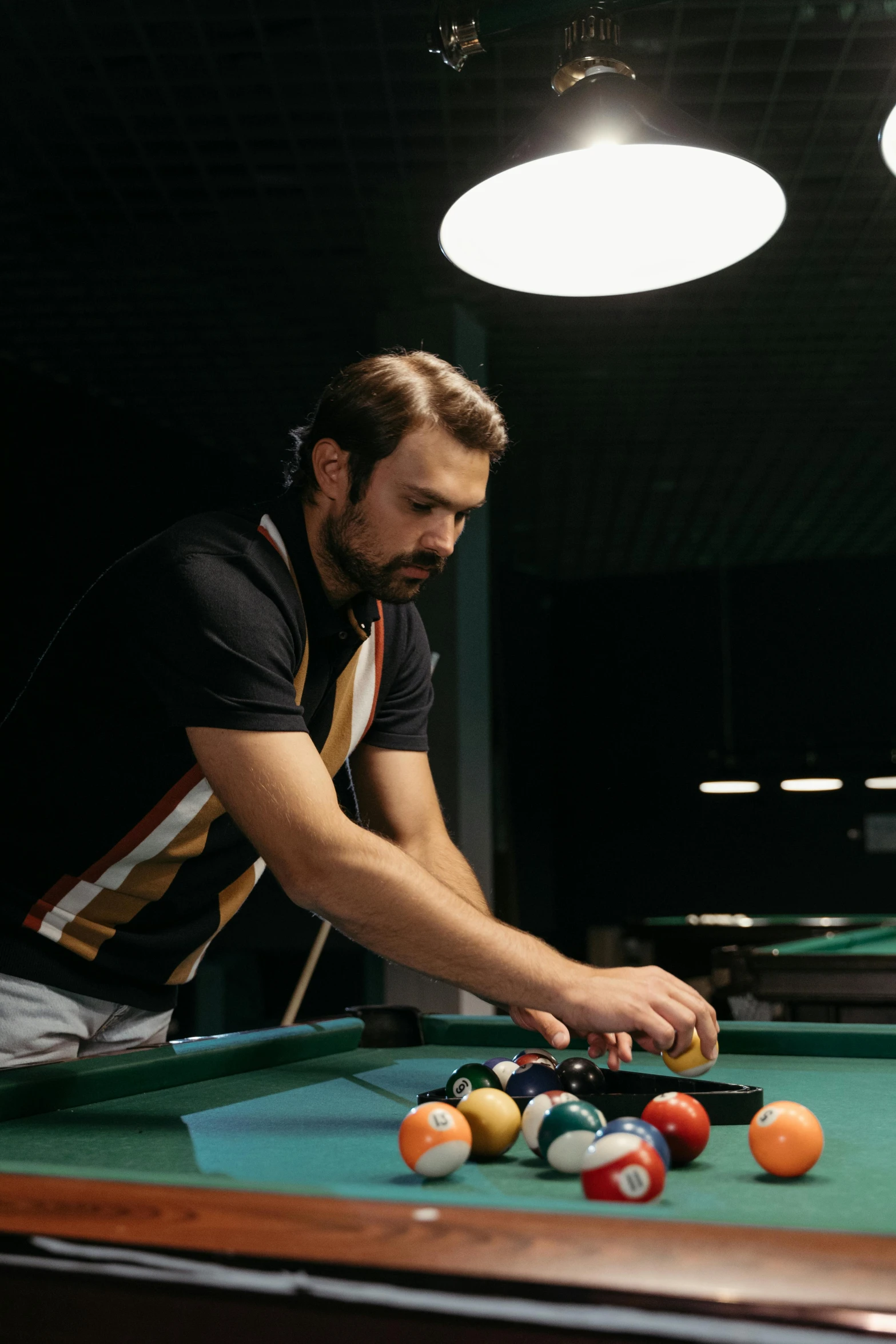 a man holding a pool cue in his hand