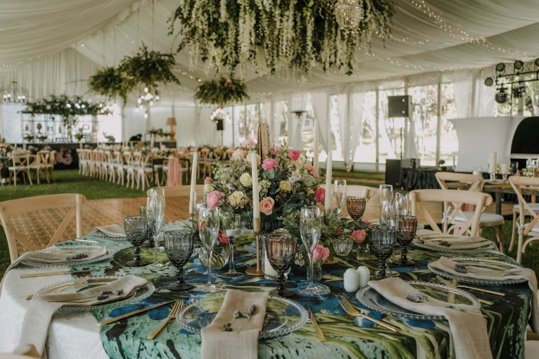 table setting in tent with chandelier and decorations