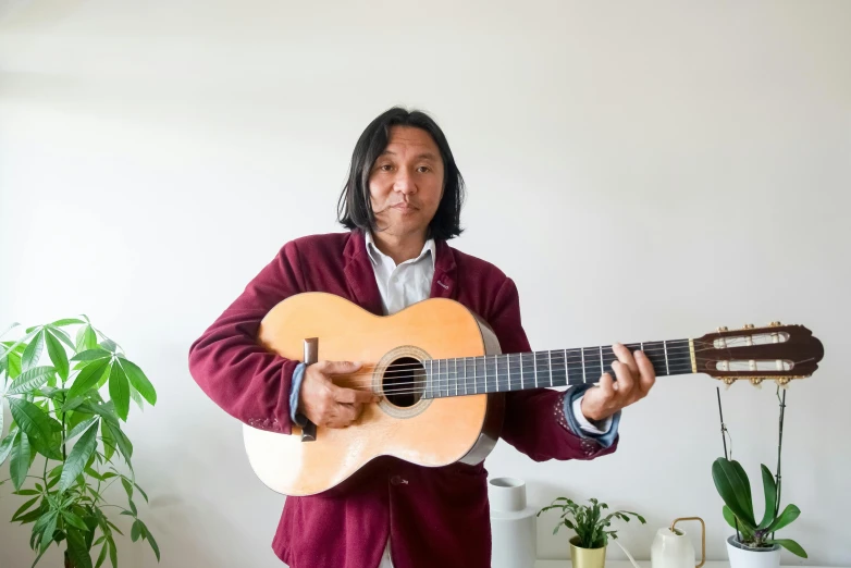 a man in a suit holding a guitar