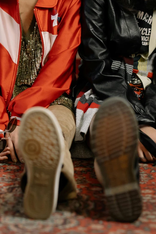 two young women are sitting close to one another