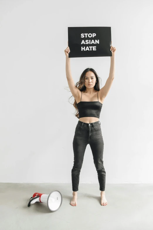 a woman is holding up a sign