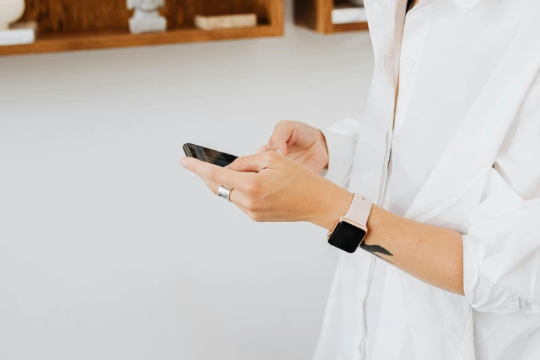 a person wearing a wristband and holding a cell phone