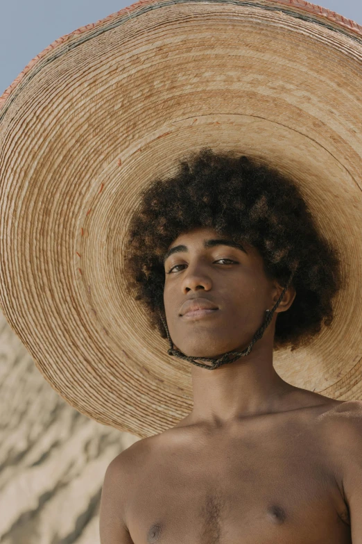 a young man wearing an unusual hat