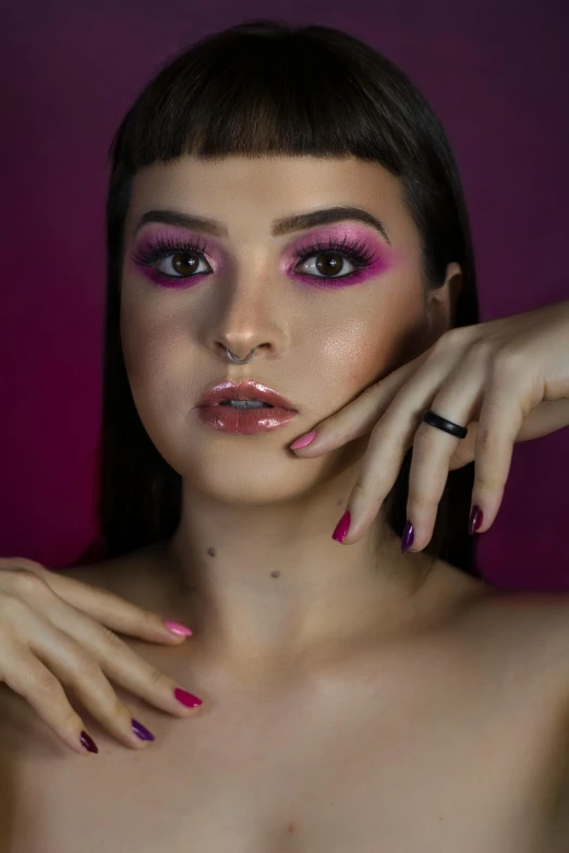 a young woman with dark hair and pink eyeshades