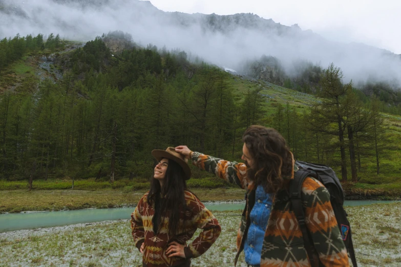 two people are standing on the ground in the rain