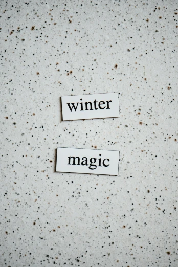 white paper tags with text that read winter and magic