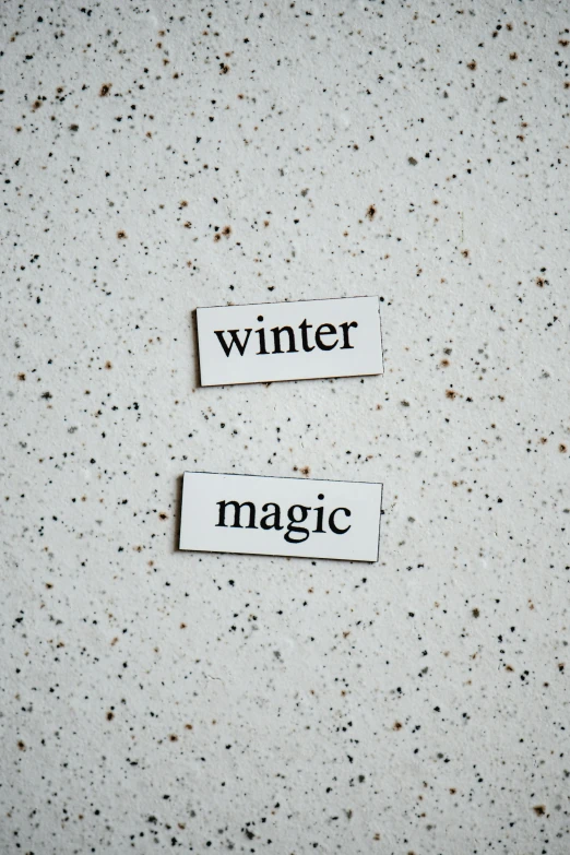 white paper tags with text that read winter and magic