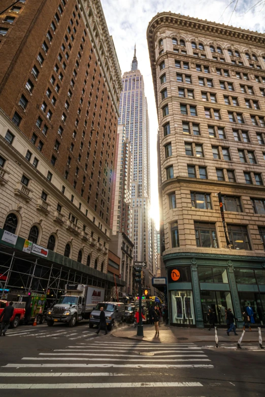 an intersection is shown with tall buildings and other vehicles