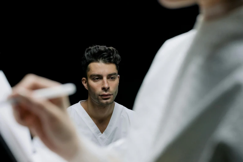 a young man is talking to an instructor