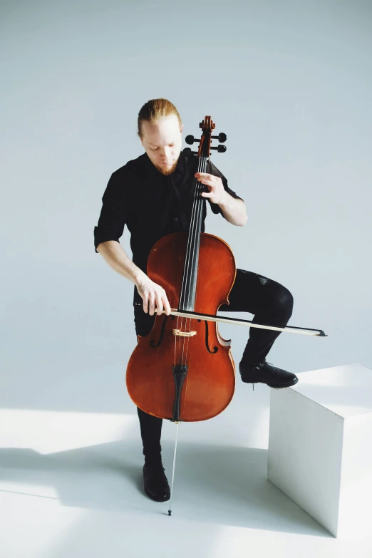 a man holding an instrument while standing on steps