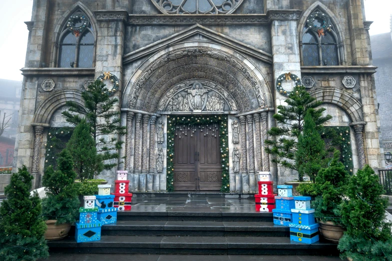 an ornate church with two christmas tree - filled steps