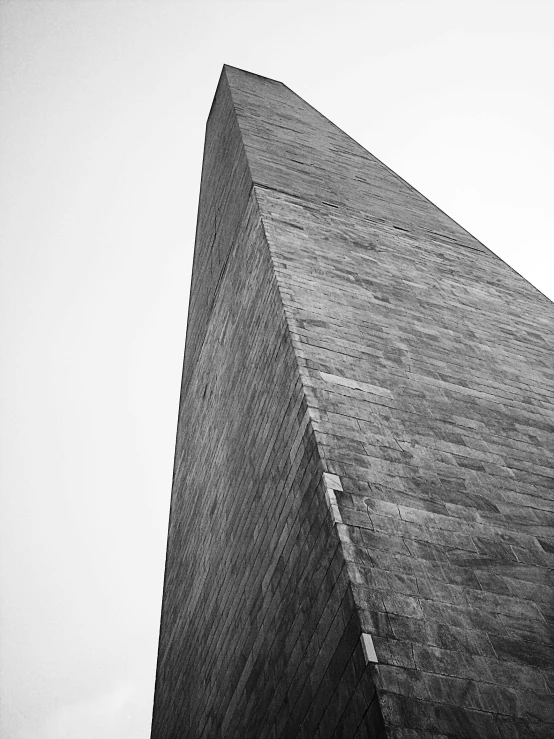 a tall stone building has a light house on it's side