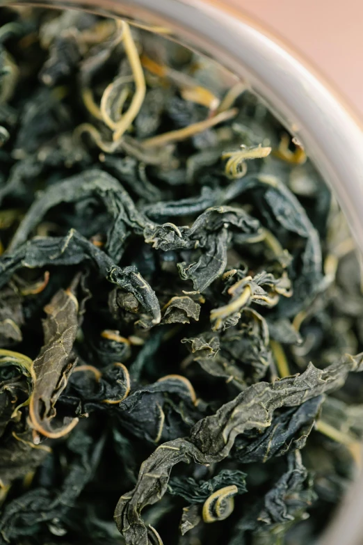 a bowl of dry black leaves filled with water