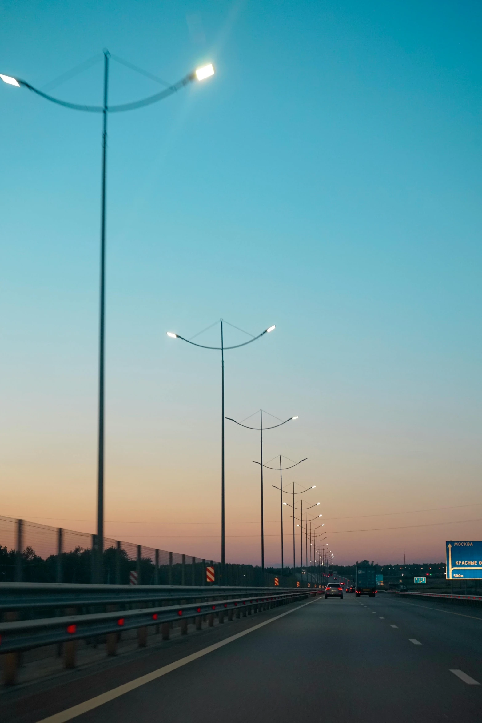 a street that has several lamps on either side of the road