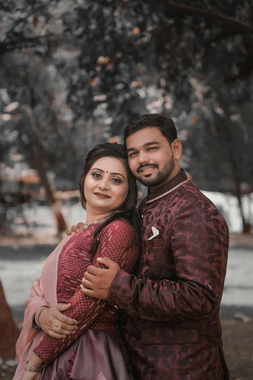 a man and woman in formal wear posing for the camera