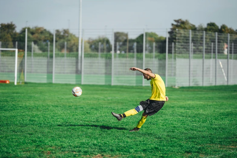 a  prepares to kick a soccer ball