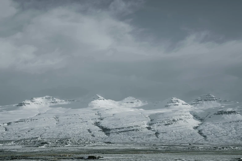 the snow is melting and the mountains are barren